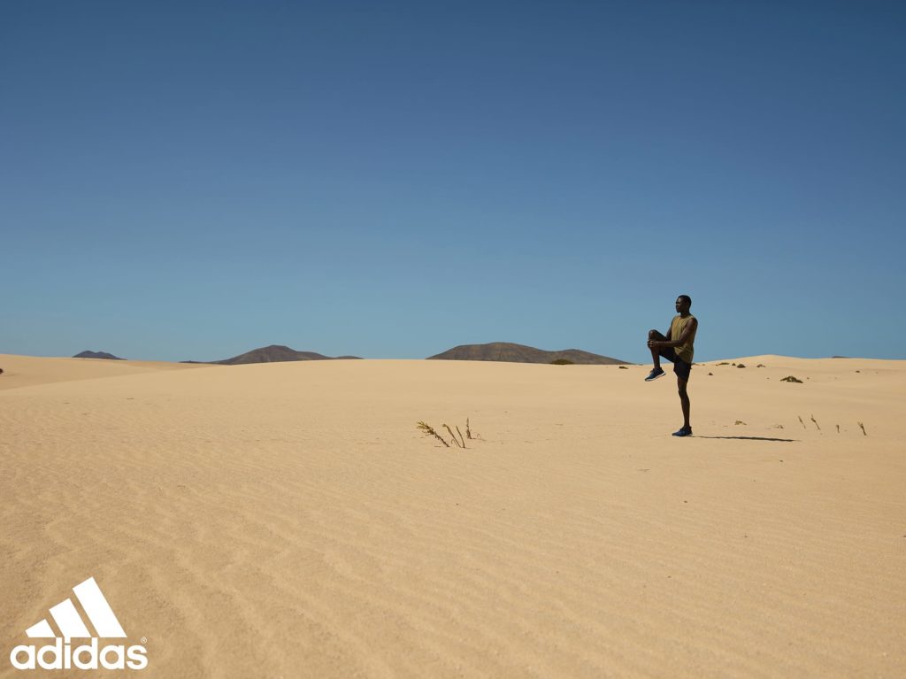 Black male athlete stretching his leg in Adidas Climachill campaign photography