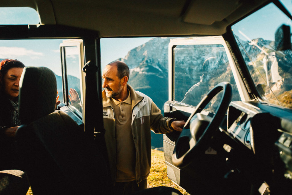 Commissionable artist Trevor Hawkins captures pic of male guide getting into the car to drive through mountains in Berguedà.